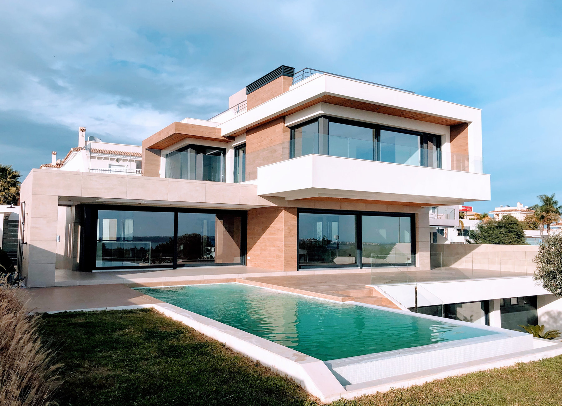 Contemporary home with a light exterior and pool, from the Stucco Check website